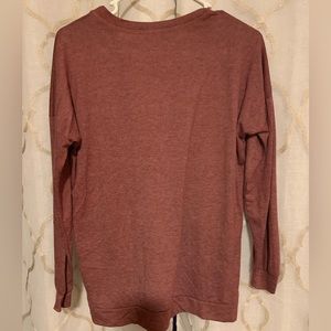 Medium long sleeve, maroon shirt with saying on the front